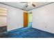 This bedroom features a ceiling fan and a door to the closet and hallway at 3052 S Joplin Ct, Aurora, CO 80013