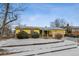 A yellow house with a front yard covered in snow and some bushes visible at 3052 S Joplin Ct, Aurora, CO 80013