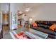 Living room with a comfortable brown sofa, stylish coffee table, adjacent to a well-equipped kitchen at 625 S Clinton St # 6B, Denver, CO 80247