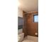 Cozy bathroom with shower, brown tiling, and a built in cabinet for storage at 1977 S Josephine St # 101, Denver, CO 80210
