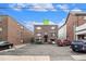 Functional apartment building featuring brick exterior and a practical parking area at 1977 S Josephine St # 101, Denver, CO 80210