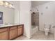 Bathroom featuring a vanity with granite countertop, soaking tub with tiled surround, and modern fixtures at 9180 Rolling Way # 303, Parker, CO 80134