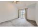 Bright bedroom with neutral walls, carpeted floors, and sliding glass doors to a balcony at 9180 Rolling Way # 303, Parker, CO 80134