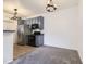 Modern kitchen with stainless steel appliances, blue cabinets, and views into the living space at 9180 Rolling Way # 303, Parker, CO 80134