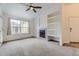 Cozy living room with a fireplace, built-in shelves, and a large window that offers ample natural light at 9180 Rolling Way # 303, Parker, CO 80134
