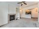 Living room featuring a fireplace and view into the kitchen at 9180 Rolling Way # 303, Parker, CO 80134