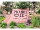 Entrance sign for Prairie Walk on Cherry Creek with lush greenery around the base of the sign at 9180 Rolling Way # 303, Parker, CO 80134