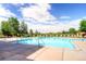 Outdoor swimming pool with lounge chairs and ample space for residents to relax and enjoy the sun at 9180 Rolling Way # 303, Parker, CO 80134