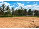 Sandy volleyball court with net set up and building in the background, perfect for outdoor recreation at 9180 Rolling Way # 303, Parker, CO 80134