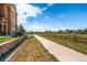 Scenic walking path beside a building with well-kept landscaping and a beautiful blue sky in a tranquil setting at 9180 Rolling Way # 303, Parker, CO 80134