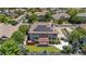 Aerial view of the home showcasing mature trees, solar panels, a backyard patio, and fenced yard at 14325 N Santa Fe St, Broomfield, CO 80023