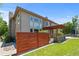 Exterior side view of the home showcasing a wooden fence and the stone patio with pergola at 14325 N Santa Fe St, Broomfield, CO 80023