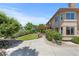 Side view of the backyard with lush green grass, mature trees, and stone patio with pergola at 14325 N Santa Fe St, Broomfield, CO 80023