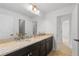Elegant bathroom features dual sinks, granite countertop, and plenty of natural light at 14325 N Santa Fe St, Broomfield, CO 80023