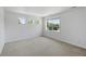 Well-lit bedroom with neutral paint and carpet, and a large window at 14325 N Santa Fe St, Broomfield, CO 80023