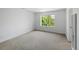 Bright bedroom with large window overlooking a green landscape and neutral carpeting at 14325 N Santa Fe St, Broomfield, CO 80023