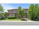 Elegant two-story home featuring a stone facade, landscaped front yard, and a gated entrance, offering both curb appeal and privacy at 14325 N Santa Fe St, Broomfield, CO 80023