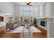 Bright living room boasts hardwood floors, a fireplace, and a wall of windows at 14325 N Santa Fe St, Broomfield, CO 80023