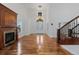 Elegant entrance and staircase featuring hardwood floors and fireplace at 14325 N Santa Fe St, Broomfield, CO 80023