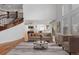 Cozy living room with hardwood floors, fireplace, and stairs with iron rails at 14325 N Santa Fe St, Broomfield, CO 80023