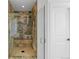 Beautiful shower with stone walls, glass door, and built in bench seat at 14325 N Santa Fe St, Broomfield, CO 80023