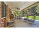 Covered porch with ceiling fan, brick support columns and many seating options at 7573 S Saulsbury Ct, Littleton, CO 80128
