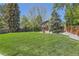 Manicured lawn with mature trees and privacy fence, perfect for outdoor gatherings and relaxation at 7573 S Saulsbury Ct, Littleton, CO 80128
