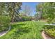 Expansive backyard showcasing well-maintained lawn and mature trees with landscaping at 7573 S Saulsbury Ct, Littleton, CO 80128