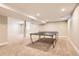 Spacious finished basement with neutral walls, recessed lighting, and carpet flooring; table tennis at 7573 S Saulsbury Ct, Littleton, CO 80128