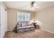 Bedroom featuring carpet, closet, modern ceiling fan and shuttered window at 7573 S Saulsbury Ct, Littleton, CO 80128