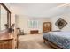 Spacious bedroom features natural light, carpet, and comfortable furnishings at 7573 S Saulsbury Ct, Littleton, CO 80128