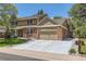 Attractive two-story home with brick accents, attached garage, and concrete driveway at 7573 S Saulsbury Ct, Littleton, CO 80128