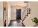 Welcoming foyer with slate flooring and a staircase with carpet runners at 7573 S Saulsbury Ct, Littleton, CO 80128