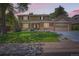 Charming two-story home with a brick facade, manicured lawn, and attached two-car garage at 7573 S Saulsbury Ct, Littleton, CO 80128