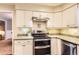 Modern kitchen with stainless steel appliances, light countertops, and efficient layout at 7573 S Saulsbury Ct, Littleton, CO 80128