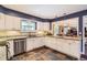 Elegant kitchen with white cabinets, granite countertops, and stainless steel appliances at 7573 S Saulsbury Ct, Littleton, CO 80128