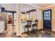 Well-designed kitchen with granite countertops, bar seating, and slate tile flooring at 7573 S Saulsbury Ct, Littleton, CO 80128