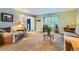 Bright living room with plush carpet and a view into the foyer entrance at 7573 S Saulsbury Ct, Littleton, CO 80128