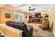 Spacious living room with a brick fireplace and a large window offering ample natural light at 7573 S Saulsbury Ct, Littleton, CO 80128