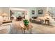 Open-concept living room and dining area with neutral decor and soft natural light at 7573 S Saulsbury Ct, Littleton, CO 80128