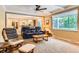 Bright living room features a large picture window, plush seating and neutral carpet at 7573 S Saulsbury Ct, Littleton, CO 80128
