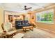 Cozy living room showcasing natural light, backyard views, and seamless flow to the dining area at 7573 S Saulsbury Ct, Littleton, CO 80128