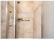 Tiled shower includes grab bars and a glass door at 7573 S Saulsbury Ct, Littleton, CO 80128