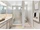 Modern bathroom features a glass enclosed shower, double sink vanity, and adjacent toilet room at 2578 Palau Way, Castle Rock, CO 80109
