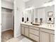 Spacious bathroom with double vanity, generous mirror, closet, and soft neutral tones for relaxation at 2578 Palau Way, Castle Rock, CO 80109