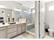 Elegant bathroom includes a glass shower, vanity with dual sinks, and a separate toilet area at 2578 Palau Way, Castle Rock, CO 80109