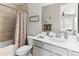 Bathroom featuring a shower with curtain, framed mirror, and white vanity at 2578 Palau Way, Castle Rock, CO 80109