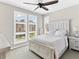 Bright bedroom with whitewashed furniture set, ceiling fan and large windows with shutters at 2578 Palau Way, Castle Rock, CO 80109