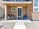 Inviting front porch with seating and decorative flowerpots offers a cozy welcome to this charming home at 2578 Palau Way, Castle Rock, CO 80109