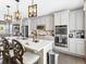 Bright kitchen features a central island, stainless appliances, white cabinets, and stylish pendant lighting at 2578 Palau Way, Castle Rock, CO 80109